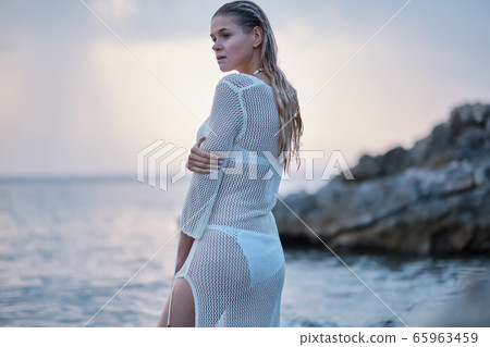 fit woman in posing on beach. Stylish look woman fit woman in posing on beach. Stylish look woman 65963459