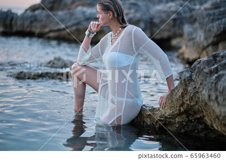 fit woman in posing on beach. Stylish look woman fit woman in posing on beach. Stylish look woman 65963460