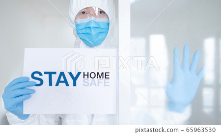 Doctor showing paper stay home stay safe 65963530