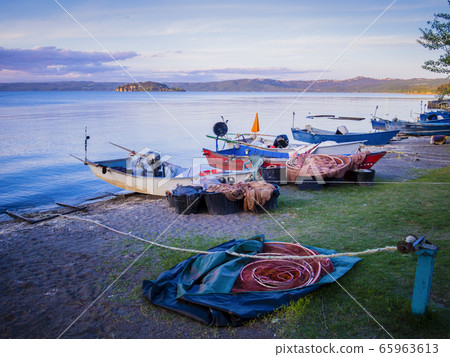 Row of typical fishermen boats docked on Marta beach, a little medieval village on Bolsena lakeshore, Viterbo province, Lazio, Italy 65963613