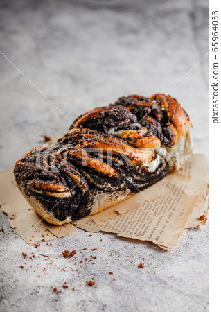 Babka cake with poppy seeds on concrete texture 65964033