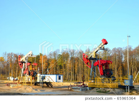 Oil drilling derricks at desert oilfield for fossil fuels output and crude oil production Oil drilling derricks at desert oilfield for fossil fuels output and crude oil production 65965364