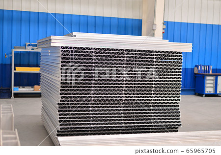 Aluminum profile in the production hall of an industrial plant 65965705