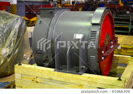 Synchronous traction generator with a cylindrical rotor in the production hall of automobile plant 65966309