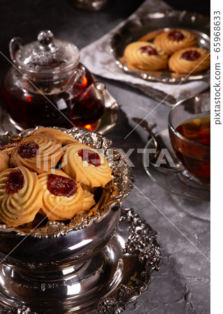 Tea and cookies in vintage utensils on a gray Tea and cookies in vintage utensils on a gray 65968633