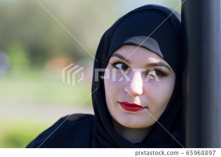Sad woman in muslim clothes. Sad woman in muslim clothes. 65968897