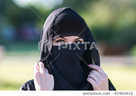 Portrait of a muslim woman in black clothes. Portrait of a muslim woman in black clothes. 65968918
