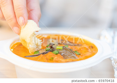 Image of eating takeaway Indian curry Image of eating takeaway Indian curry 65970418