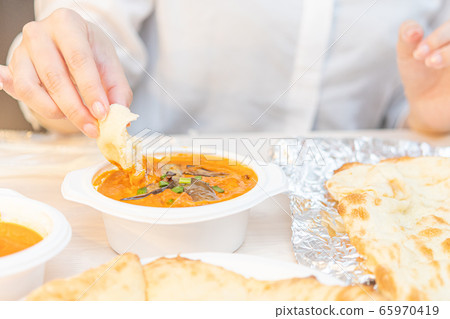 Image of eating takeaway Indian curry Image of eating takeaway Indian curry 65970419