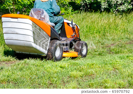 Green grass lawn and professional tractor 65970792