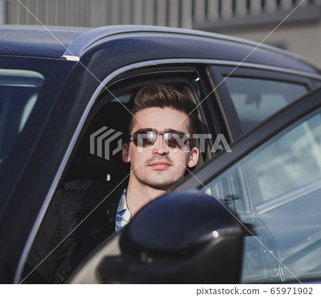 elegant man in car 65971902
