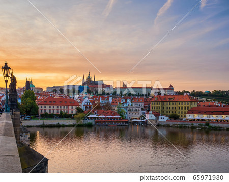 Amazing sunset over Prague town, Vltava river and Vitus Cathedral 65971980