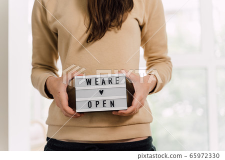 open again sigh on wooden table. local business reopen after quarantine covid-19 open again sigh on wooden table. local business reopen after quarantine covid-19 65972330