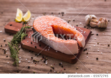 Salmon with lemon, pepper and rosemary. Keto diet, pescetarianism and healthy food concept. Salmon with lemon, pepper and rosemary. Keto diet, pescetarianism and healthy food concept. 65972745