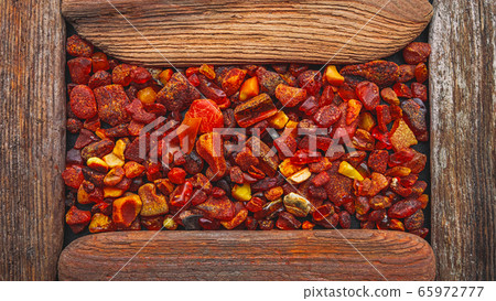 Amber stones framed in a wooden frame 65972777