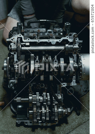 Disassembled fast motorcycle engine with visible Transmission and locking valve. Sixteen valves and four cylinder. 65972804