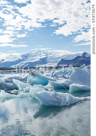 Amazing view of white icebergs and ice floes in Jokulsarlon glacier lagoon. Travel destination. Natural wonder. Beautiful Icelandic landscape Amazing view of white icebergs and ice floes in Jokulsarlon glacier lagoon. Travel destination. Natural wonder. Beautiful Icelandic landscape 65973674