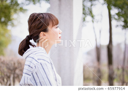 Profile of an Asian woman outdoors (sad, blank, dumbfounded) Profile of an Asian woman outdoors (sad, blank, dumbfounded) 65977914