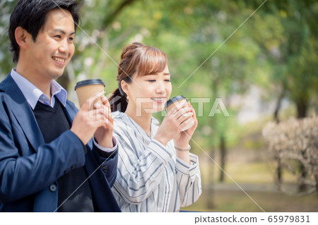 Asian couple drinking coffee together Asian couple drinking coffee together 65979831