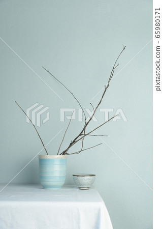 blue tea cup with dry tree branch on wood table blue tea cup with dry tree branch on wood table 65980171