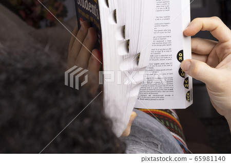 Young woman browse words through English Young woman browse words through English 65981140