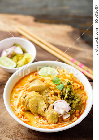 Northern Thai food (Khao Soi), spicy curry noodles soup with coconut milk and chicken in a bowl 65983087
