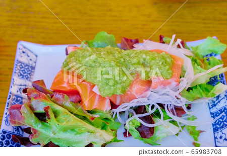 Vegetable salad with salmon slice on top with spice seafood sauce Vegetable salad with salmon slice on top with spice seafood sauce 65983708
