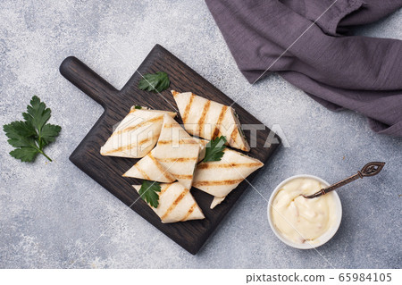 Roll with cheese and herbs. Grilled pita bread with filling. Cucumber radish salad. The concept of a healthy Breakfast. Roll with cheese and herbs. Grilled pita bread with filling. Cucumber radish salad. The concept of a healthy Breakfast. 65984105
