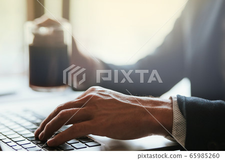 office worker typing on keyboard of laptop indoors office worker typing on keyboard of laptop indoors 65985260