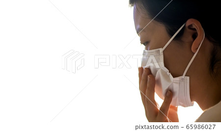 Side profile of woman with white mask close up and copy space 65986027