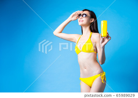asian bikini girl take sunscreen asian bikini girl take sunscreen 65989029