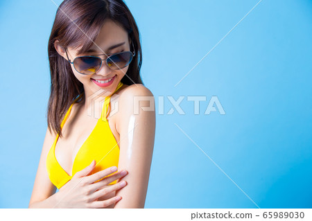 woman apply sunscreen on arm woman apply sunscreen on arm 65989030