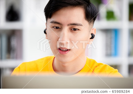 student using laptop at home 65989284