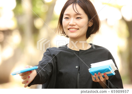 Woman giving out tissue Woman giving out tissue 65989937