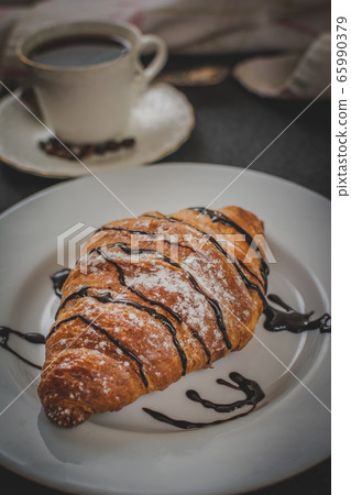 Croissant with chocolate and coffee 65990379