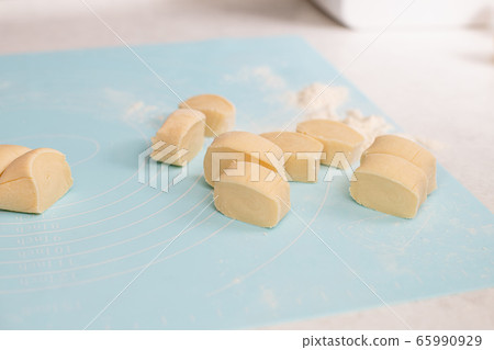 Cuted pieces of yellow healthy flour dough 65990929