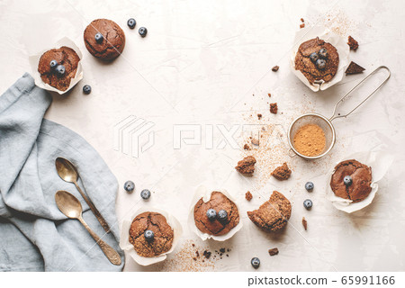 Homemade fresh chocolate muffins with berries and chocolate pieces. 65991166