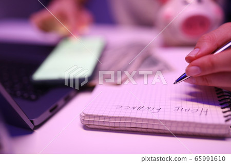 Close-up, womans hands write notepad home finances 65991610