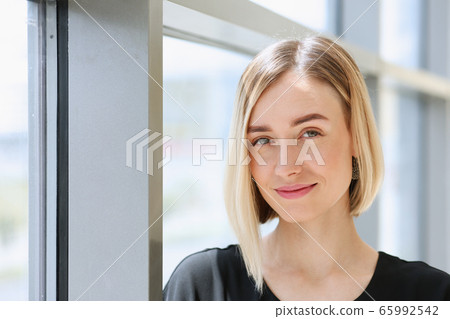 Blonde beauty businesswoman portrait look outside Blonde beauty businesswoman portrait look outside 65992542