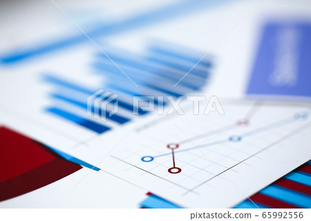 Financial statistics documents on clipboard pad at office table closeup Financial statistics documents on clipboard pad at office table closeup 65992556