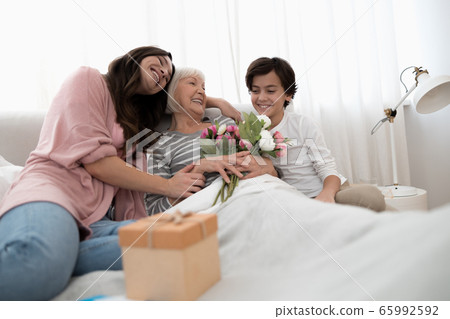 Contented woman holding a bouquet of peonies 65992592