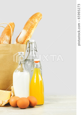 Two french baguette bread loafs in paper bag and Two french baguette bread loafs in paper bag and 65993273