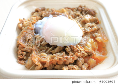 Delicious beef bowl topped with soft-boiled eggs Delicious beef bowl topped with soft-boiled eggs 65993691