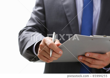 Male hand holding silver pen 65994255