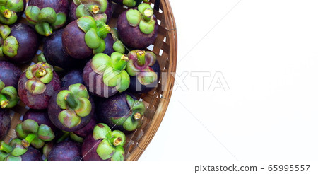 Mangosteen in wooden bamboo threshing basket  65995557