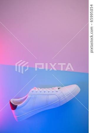 Pair of sneakers on color background, top view 65995854