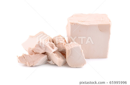 Fresh pressed yeast, isolated on white background. 65995996
