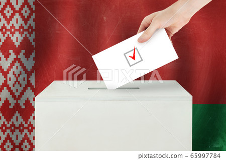Belarusian Vote concept. Voter hand holding ballot Belarusian Vote concept. Voter hand holding ballot 65997784