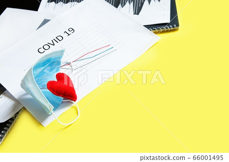End of pandemic coronavirus and isolation. Used crumpled medical mask and felt heart on chart End of pandemic coronavirus and isolation. Used crumpled medical mask and felt heart on chart 66001495