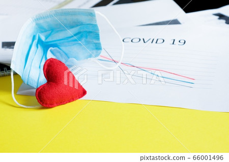 End of pandemic coronavirus and isolation. Used crumpled medical mask and felt heart on chart End of pandemic coronavirus and isolation. Used crumpled medical mask and felt heart on chart 66001496